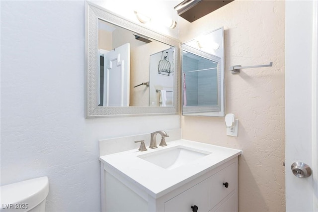 45 N Lamb Blvd, Las Vegas, NV 89110 - bathroom featuring toilet, vanity, and a textured wall