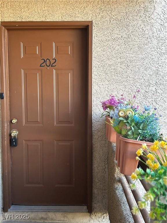6865 Tamarus St Unit 202, Las Vegas, NV 89119 - doorway to property with stucco siding