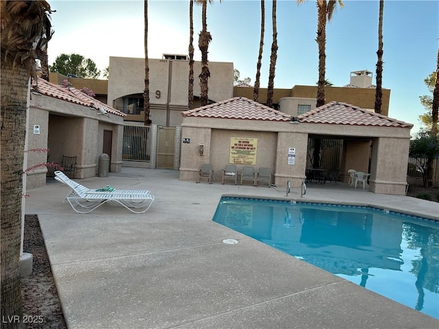 6865 Tamarus St Unit 202, Las Vegas, NV 89119 - community pool with a patio area and a gate