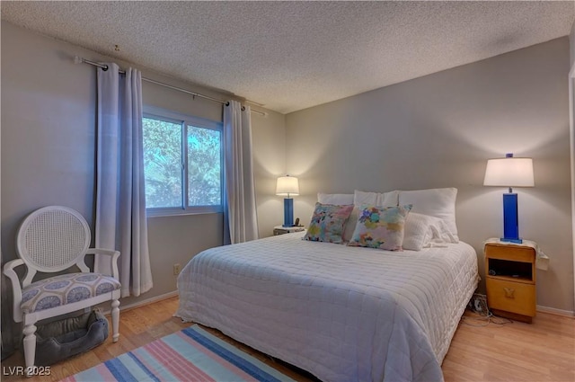 4445 Peterson Dr, Las Vegas, NV 89103 - bedroom featuring light wood-type flooring, a textured ceiling, and baseboards