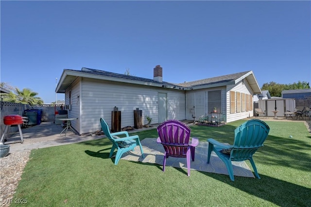4445 Peterson Dr, Las Vegas, NV 89103 - rear view of house with a storage shed, a patio area, and a chimney