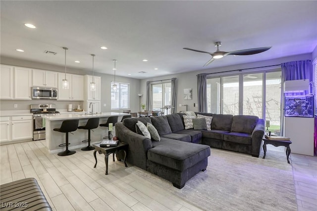 7061 Tilligerry St, North Las Vegas, NV 89084 - living area featuring light wood-type flooring, a ceiling fan, and recessed lighting