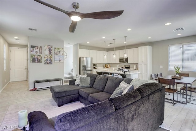 7061 Tilligerry St, North Las Vegas, NV 89084 - living room featuring light wood-style flooring, a ceiling fan, recessed lighting, and baseboards