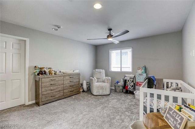 7061 Tilligerry St, North Las Vegas, NV 89084 - carpeted bedroom featuring a nursery area, a ceiling fan, and baseboards