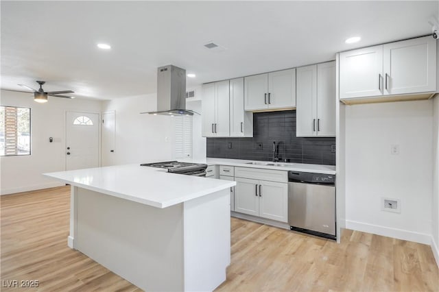 333 Rossmoyne Ave, North Las Vegas, NV 89030 - kitchen featuring stainless steel appliances, island exhaust hood, a sink, baseboards, and decorative backsplash