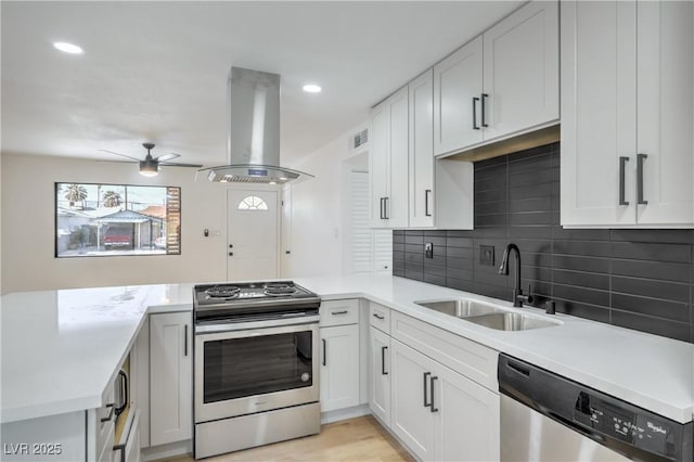 333 Rossmoyne Ave, North Las Vegas, NV 89030 - kitchen featuring appliances with stainless steel finishes, a sink, island exhaust hood, a peninsula, and light countertops