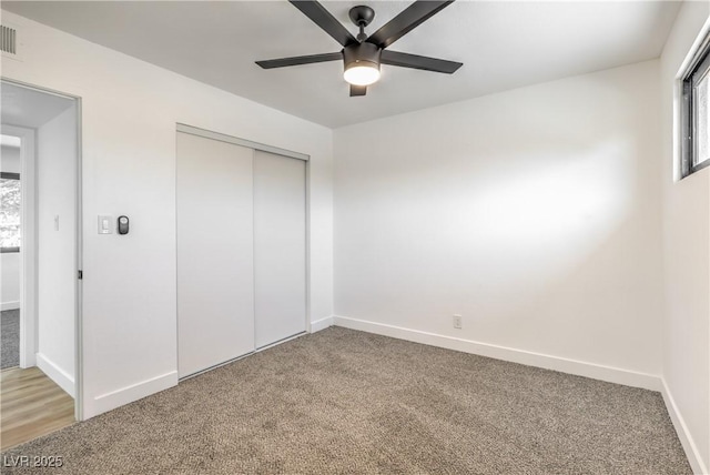 333 Rossmoyne Ave, North Las Vegas, NV 89030 - unfurnished bedroom with light colored carpet, a closet, baseboards, and ceiling fan