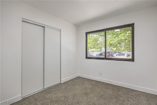 333 Rossmoyne Ave, North Las Vegas, NV 89030 - unfurnished bedroom with carpet flooring, baseboards, and a closet