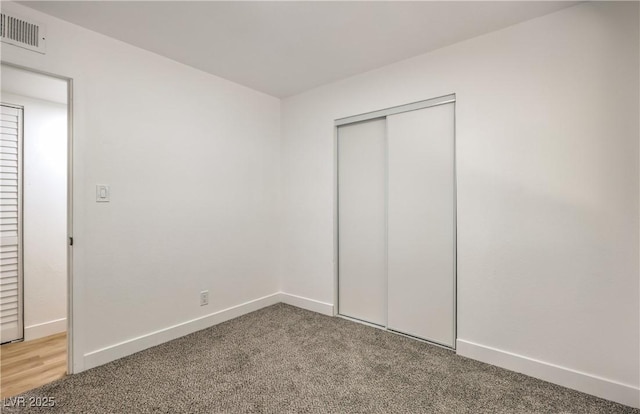 333 Rossmoyne Ave, North Las Vegas, NV 89030 - unfurnished bedroom featuring light carpet, a closet, and baseboards