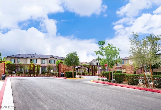 7342 N Decatur Blvd Unit 5, Las Vegas, NV 89131 - view of asphalt street featuring a gate, a residential view, a gated entry, and curbs