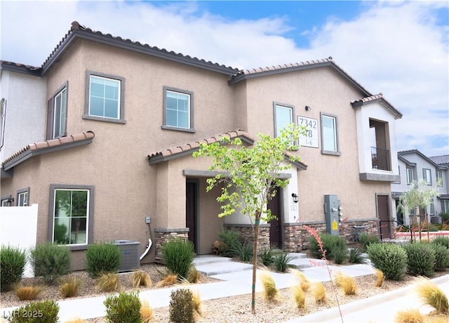 7342 N Decatur Blvd Unit 5, Las Vegas, NV 89131 - view of front of home with a tiled roof and stucco siding