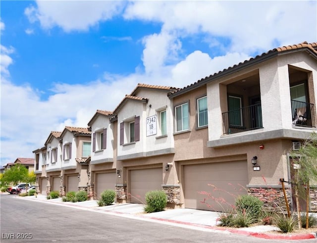 7342 N Decatur Blvd Unit 5, Las Vegas, NV 89131 - townhome / multi-family property featuring stucco siding, a garage, a tiled roof, and a residential view