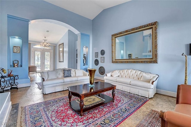 6230 Calm Brook Ct, Las Vegas, NV 89149 - living room featuring arched walkways, baseboards, french doors, a chandelier, and lofted ceiling