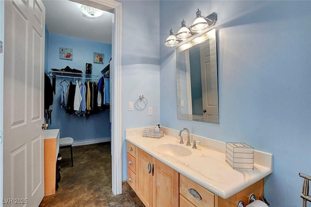 6230 Calm Brook Ct, Las Vegas, NV 89149 - bathroom with vanity, baseboards, and a spacious closet