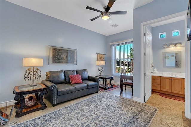 6230 Calm Brook Ct, Las Vegas, NV 89149 - living room with ceiling fan, baseboards, and light marble finish flooring