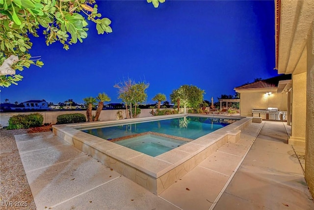 6230 Calm Brook Ct, Las Vegas, NV 89149 - pool at night with an in-ground hot tub, an outdoor kitchen, an outdoor pool, and a patio area
