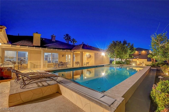 6230 Calm Brook Ct, Las Vegas, NV 89149 - pool at night featuring a patio