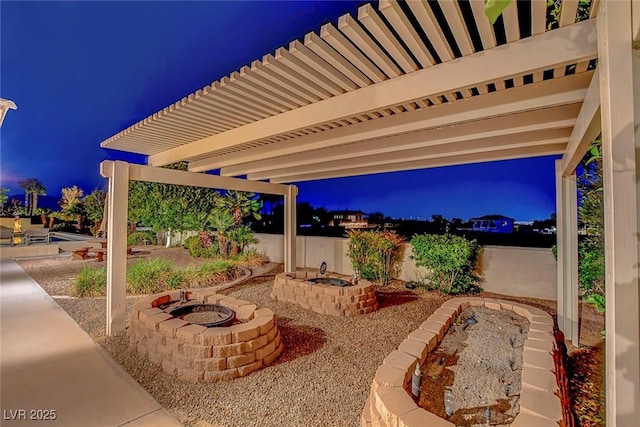 6230 Calm Brook Ct, Las Vegas, NV 89149 - patio at night featuring a fire pit and a patio