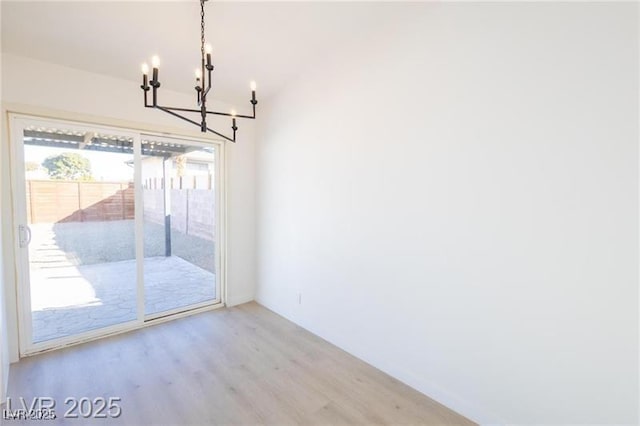 6170 W University Ave, Las Vegas, NV 89103 - unfurnished dining area with a chandelier and wood finished floors
