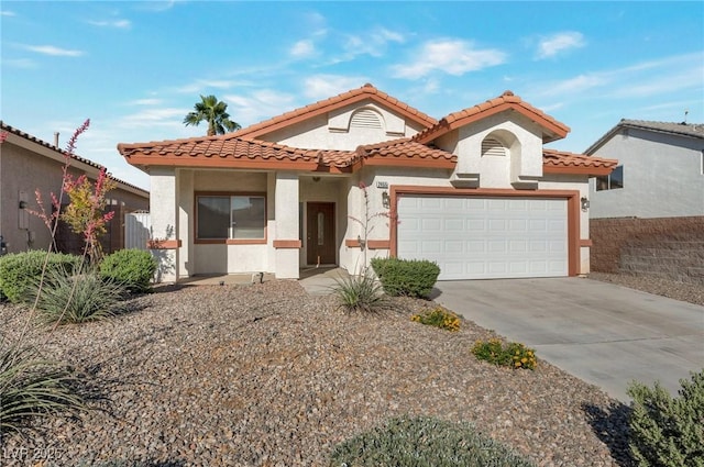 2455 Silver Blossom Ln, Henderson, NV 89052 - mediterranean / spanish-style house with an attached garage, driveway, stucco siding, and a tile roof