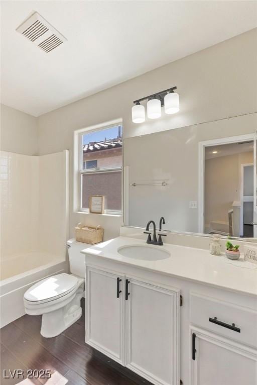 8507 Titania Ct, Las Vegas, NV 89147 - bathroom with vanity, toilet, wood finished floors, and bathing tub / shower combination