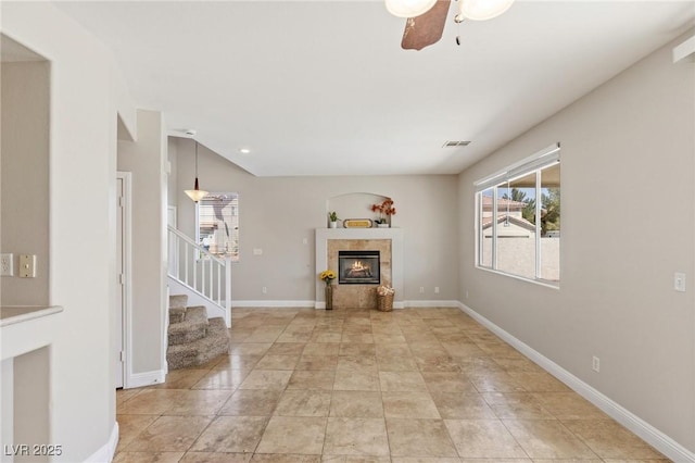 8507 Titania Ct, Las Vegas, NV 89147 - unfurnished living room with stairs, healthy amount of natural light, ceiling fan, a fireplace, and recessed lighting