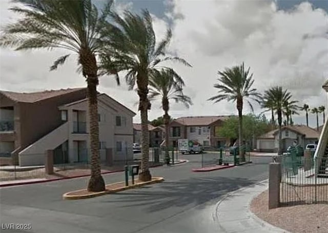 1505 Frank Aved St Unit 101, Las Vegas, NV 89110 - view of asphalt road with sidewalks, curbs, a gated entry, and a residential view