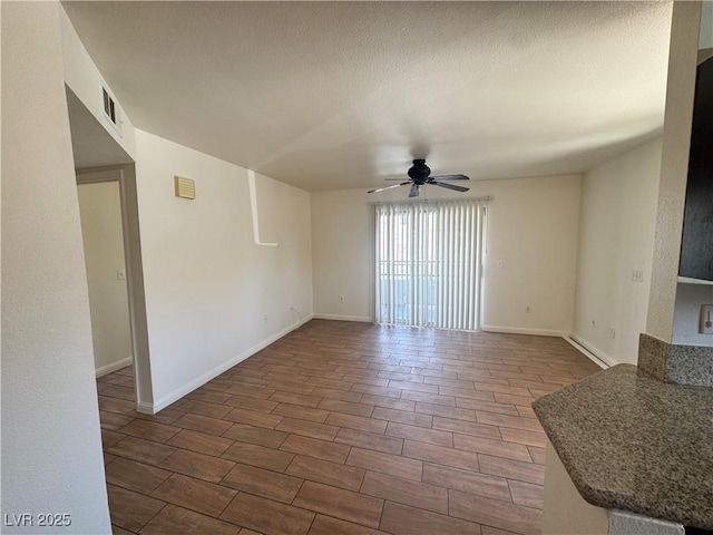1505 Frank Aved St Unit 101, Las Vegas, NV 89110 - unfurnished living room featuring ceiling fan, wood tiled floors, and a textured ceiling