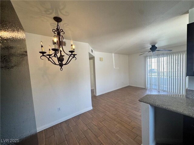 1505 Frank Aved St Unit 101, Las Vegas, NV 89110 - unfurnished dining area with ceiling fan, dark wood-style floors, and a chandelier