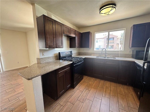 1505 Frank Aved St Unit 101, Las Vegas, NV 89110 - kitchen with gas stove, light wood finished floors, dark brown cabinets, a textured ceiling, and a peninsula