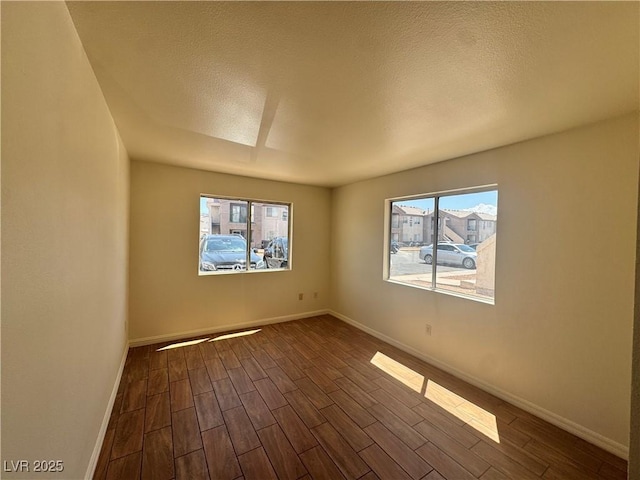 1505 Frank Aved St Unit 101, Las Vegas, NV 89110 - spare room with dark wood finished floors, plenty of natural light, and a textured ceiling