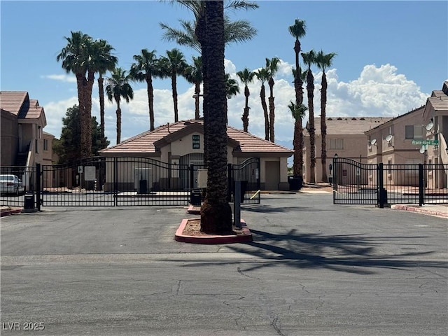 1505 Frank Aved St Unit 101, Las Vegas, NV 89110 - view of front facade featuring a gate, stucco siding, a residential view, and a tiled roof