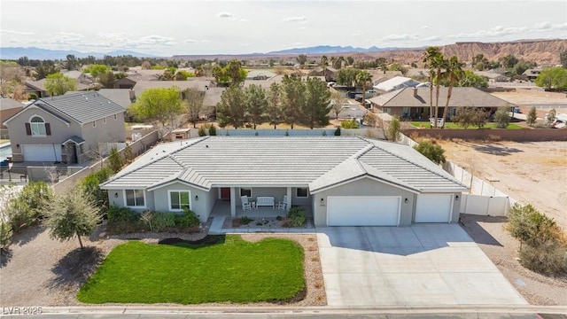 1395 Logandale Dr, Logandale, NV 89021 - view of front facade featuring a residential view, an attached garage, driveway, and a tile roof