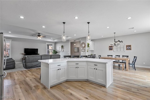 1395 Logandale Dr, Logandale, NV 89021 - kitchen with recessed lighting, light wood finished floors, a kitchen island, and white cabinets