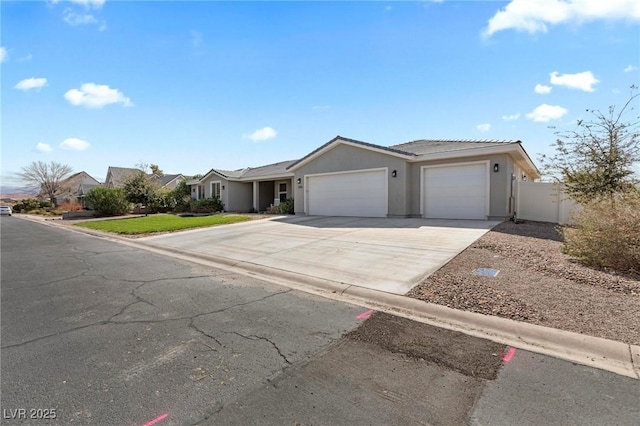1395 Logandale Dr, Logandale, NV 89021 - ranch-style house featuring a garage, driveway, and stucco siding