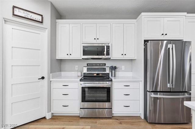 1395 Logandale Dr, Logandale, NV 89021 - kitchen featuring stainless steel appliances, light countertops, and white cabinets