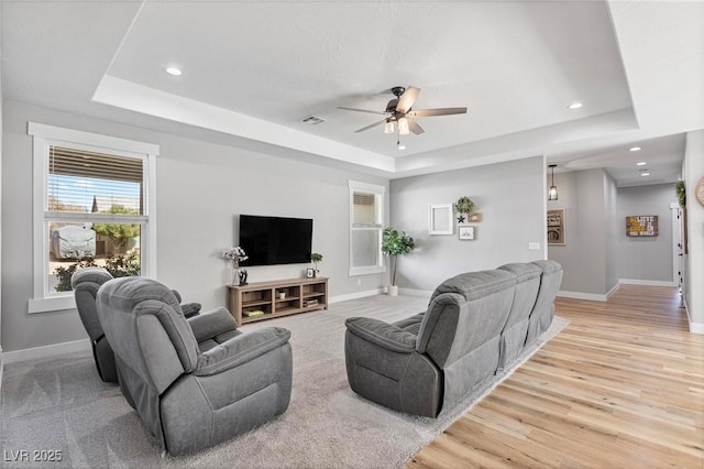 1395 Logandale Dr, Logandale, NV 89021 - living room featuring a raised ceiling, ceiling fan, baseboards, plenty of natural light, and recessed lighting