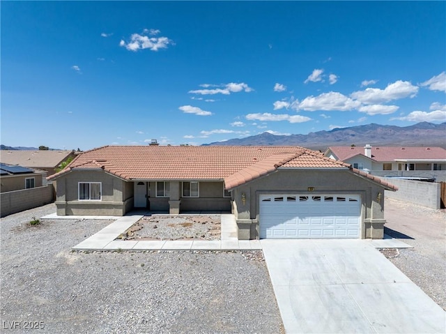654 Mazelle Ln, Pahrump, NV 89060 - single story home featuring a tile roof, stucco siding, a garage, and a mountain view