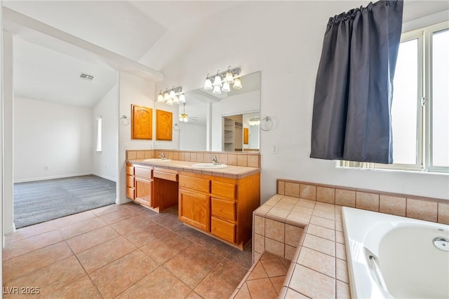 654 Mazelle Ln, Pahrump, NV 89060 - bathroom with lofted ceiling, double vanity, a bath, tile patterned floors, and a chandelier
