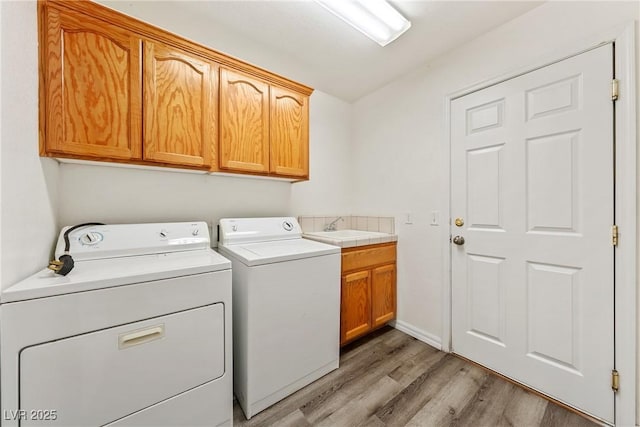 654 Mazelle Ln, Pahrump, NV 89060 - washroom with washer and clothes dryer, light wood finished floors, and cabinet space