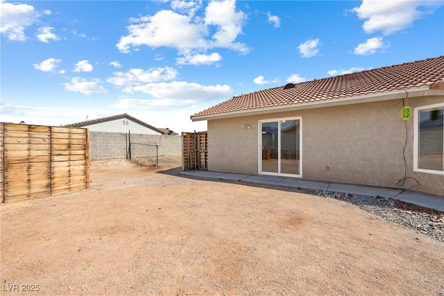 654 Mazelle Ln, Pahrump, NV 89060 - rear view of property with stucco siding and a tiled roof