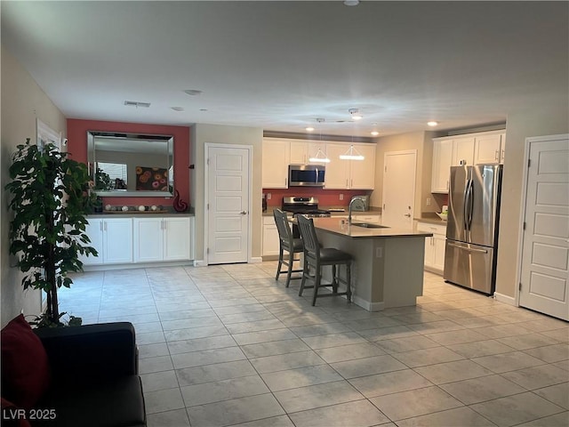 330 Silva Pl, Henderson, NV 89011 - kitchen with appliances with stainless steel finishes, light tile patterned floors, a sink, white cabinetry, and recessed lighting