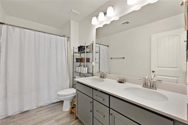 625 Honesty Ct, Henderson, NV 89011 - bathroom featuring toilet, wood finished floors, double vanity, and a shower with shower curtain