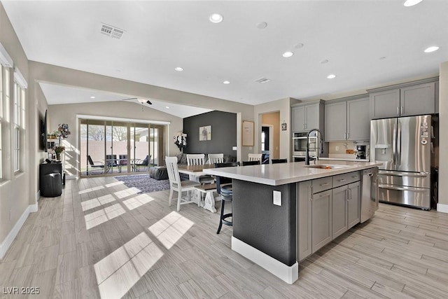 625 Honesty Ct, Henderson, NV 89011 - kitchen featuring appliances with stainless steel finishes, gray cabinetry, a sink, light countertops, and lofted ceiling