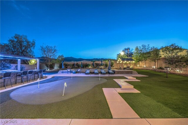 10319 Larkmead Ave, Las Vegas, NV 89149 - view of property's community with an area to practice putting, a swimming pool, a patio, and a mountain view