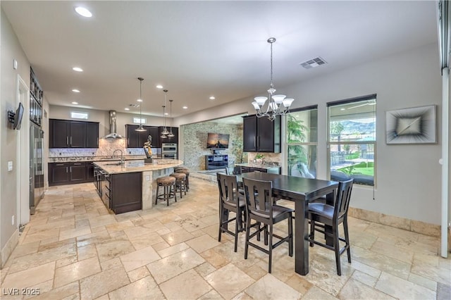 10319 Larkmead Ave, Las Vegas, NV 89149 - dining area with stone tile flooring, a chandelier, recessed lighting, and baseboards