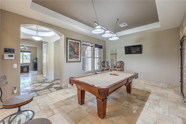 10319 Larkmead Ave, Las Vegas, NV 89149 - recreation room with a tray ceiling, stone tile flooring, and arched walkways