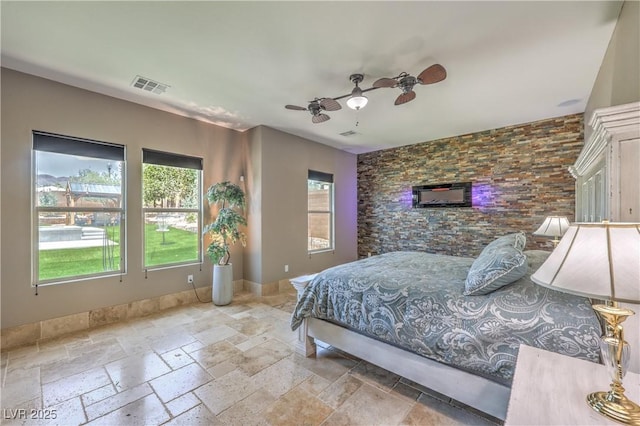 10319 Larkmead Ave, Las Vegas, NV 89149 - bedroom featuring multiple windows, stone tile floors, and a ceiling fan