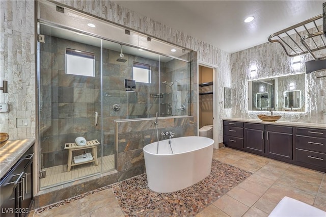 10319 Larkmead Ave, Las Vegas, NV 89149 - full bathroom with a stall shower, vanity, tile walls, a freestanding bath, and recessed lighting