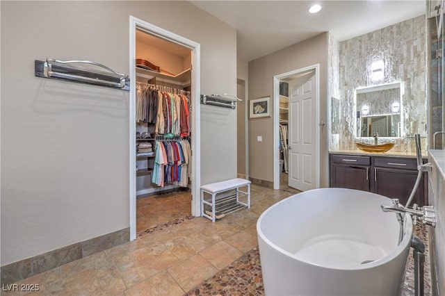 10319 Larkmead Ave, Las Vegas, NV 89149 - full bath with vanity, a freestanding tub, a walk in closet, and recessed lighting
